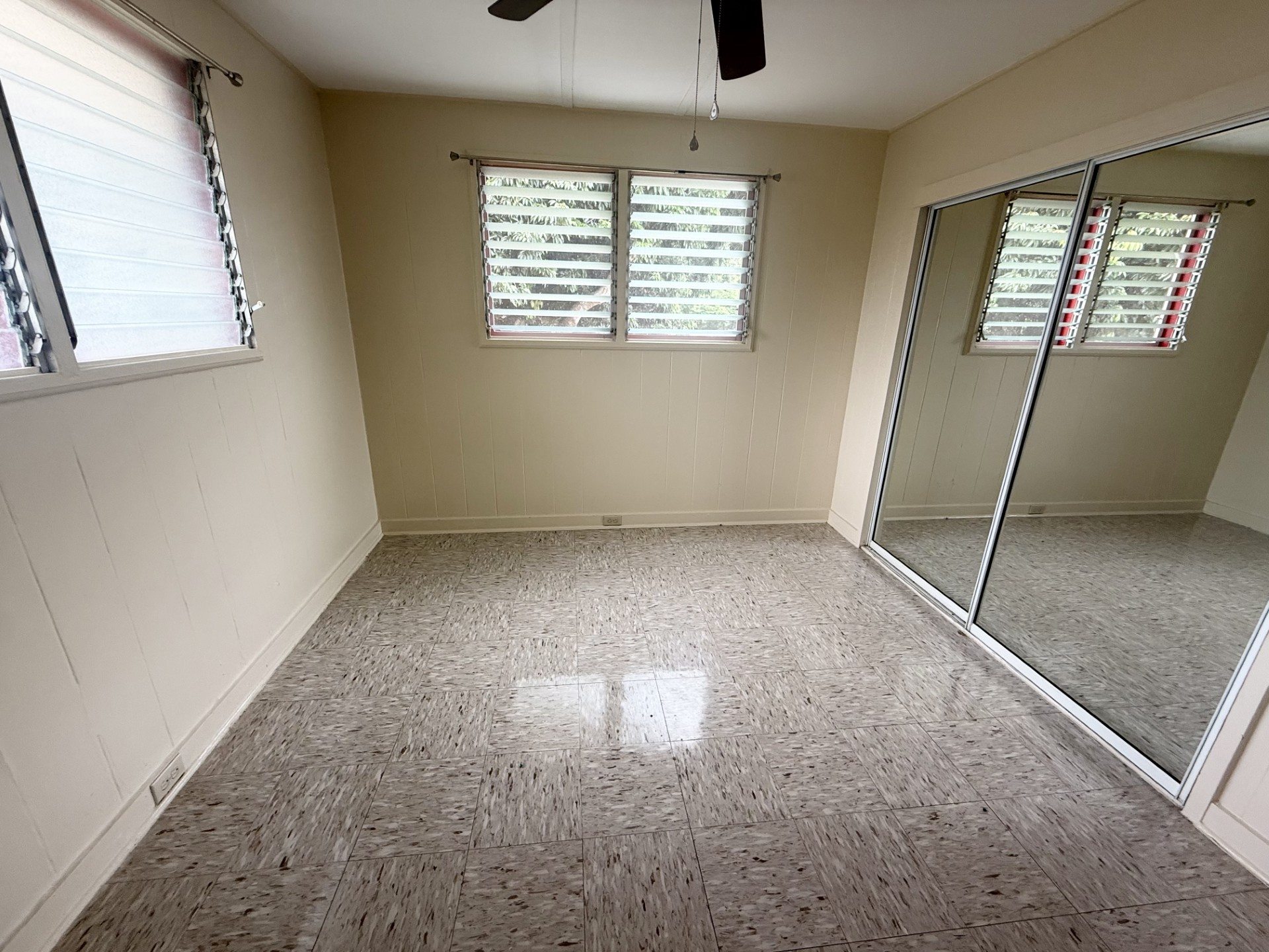 A room with a tiled floor and a glass door.