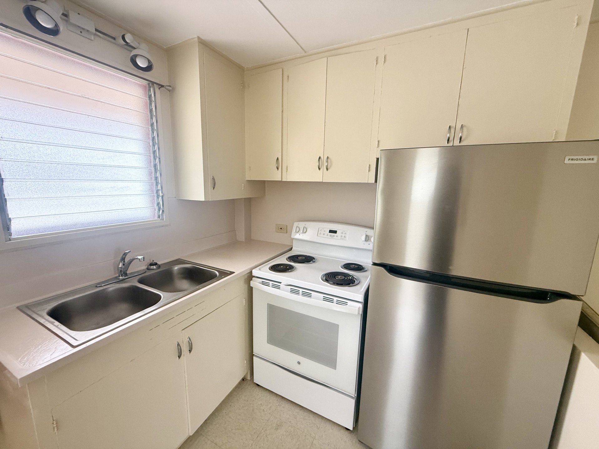 A kitchen with a stove, oven, and refrigerator.