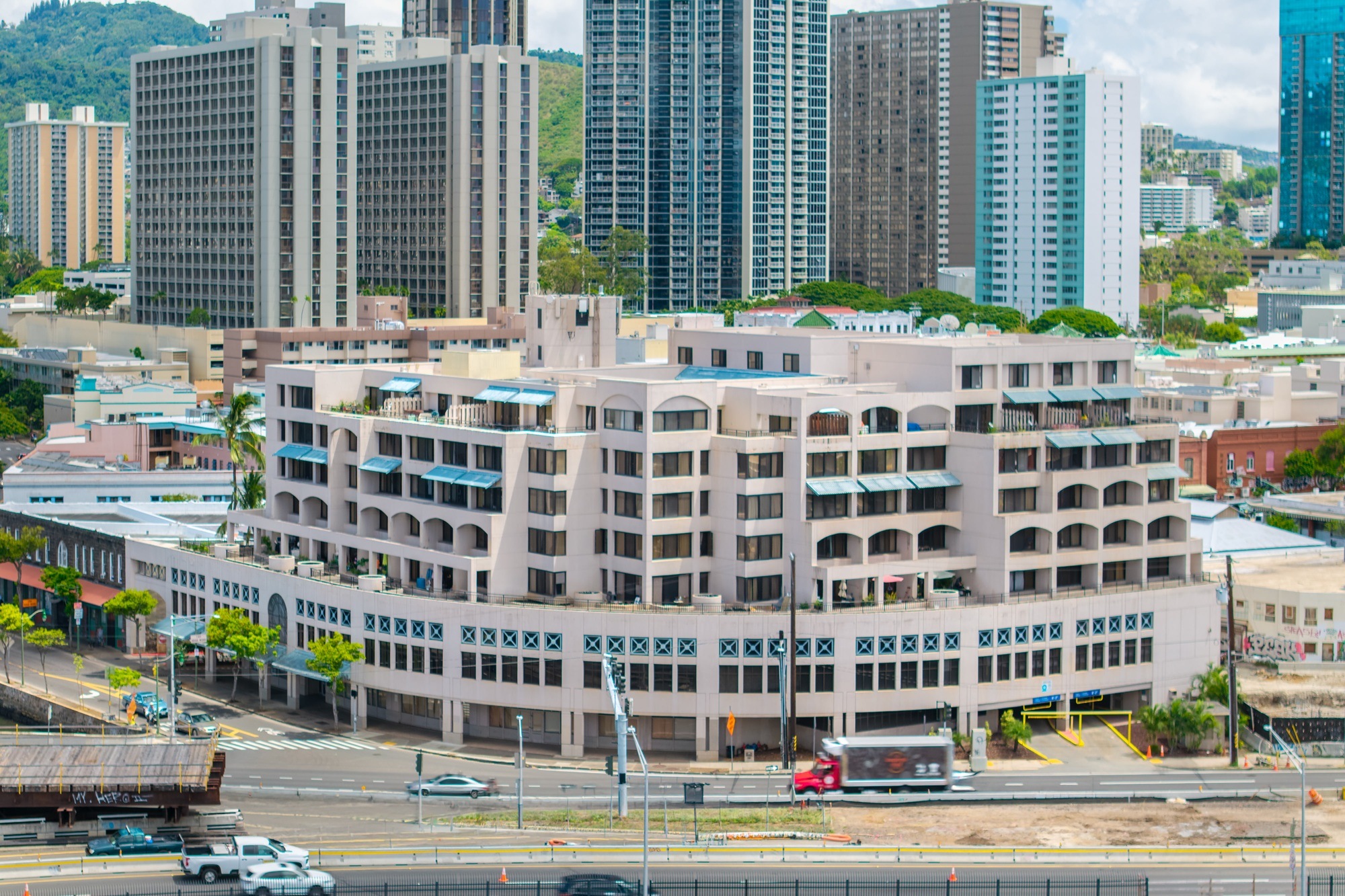 A large building with a lot of windows in the middle of a city.