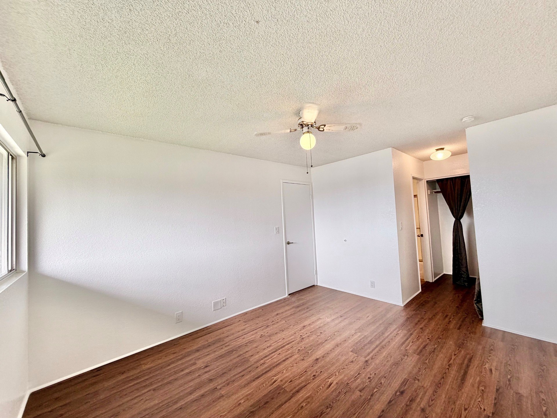 A room with wooden floors and white walls.