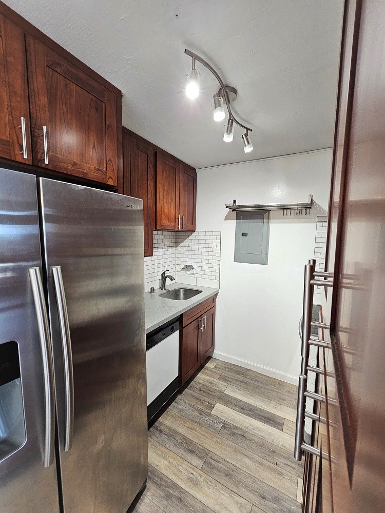 a kitchen with wooden cabinets and stainless steel appliances