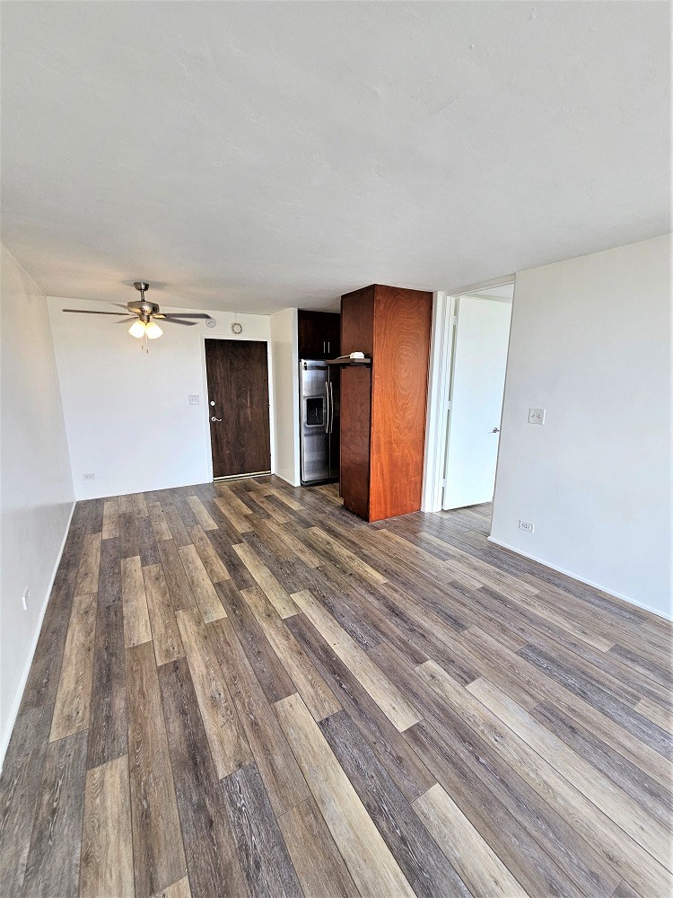 a living room with hardwood floors and white walls