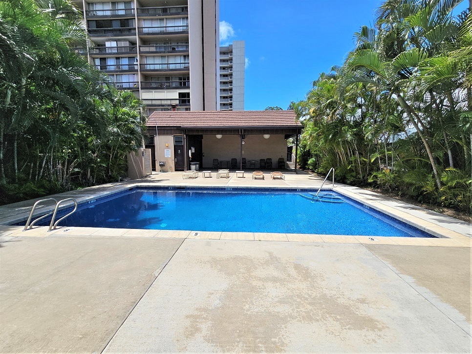 a swimming pool with a building in the background