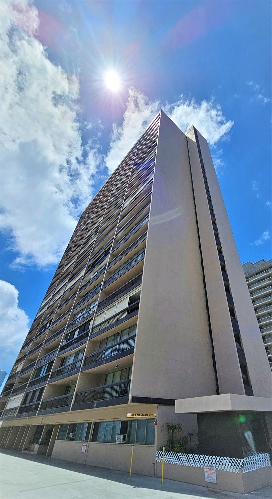 a tall building with a blue sky in the background