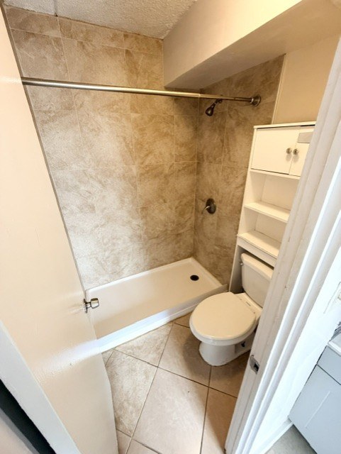 A bathroom with a toilet, tub, and shower.