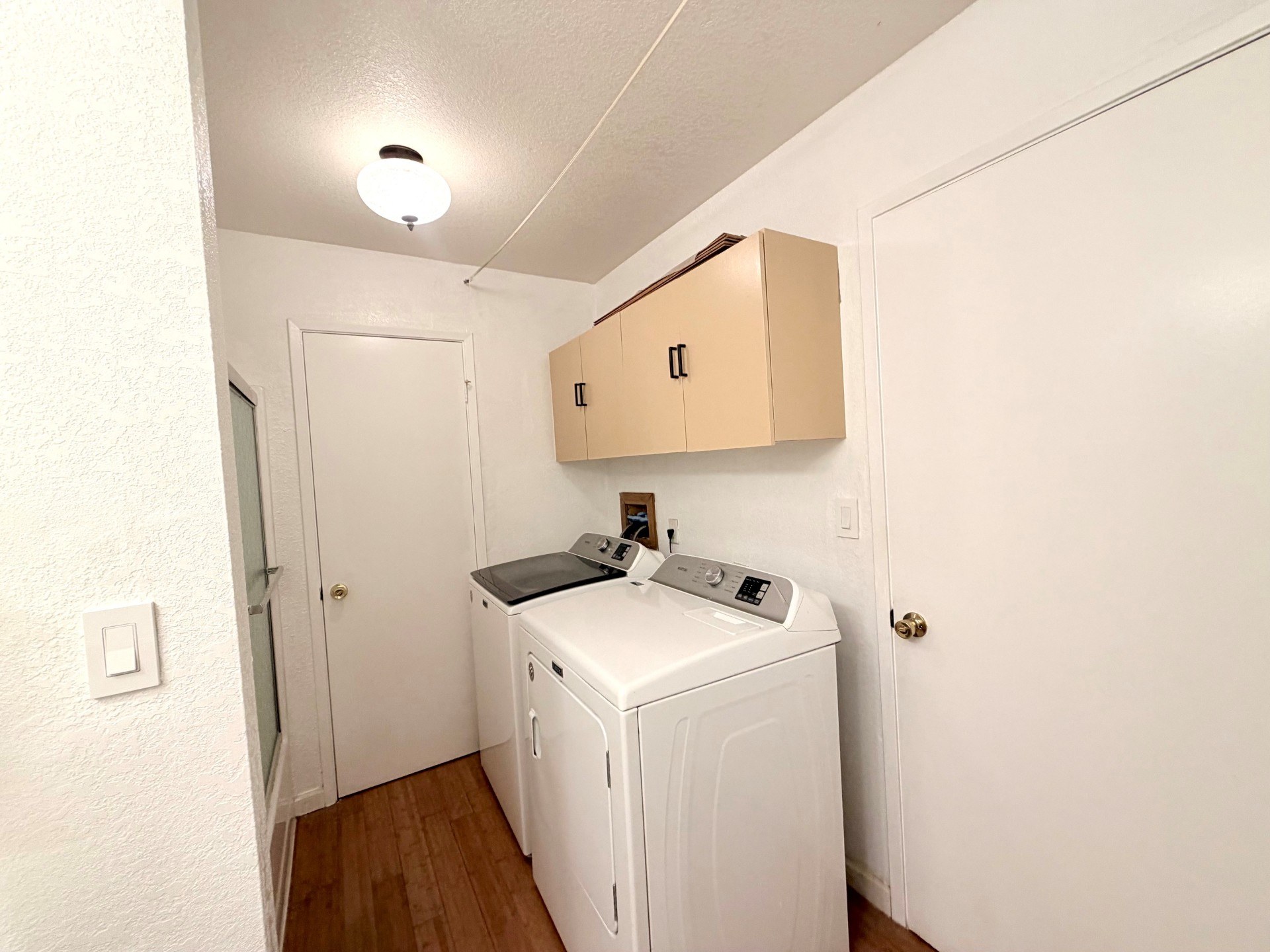 A small laundry room with a washer and dryer.