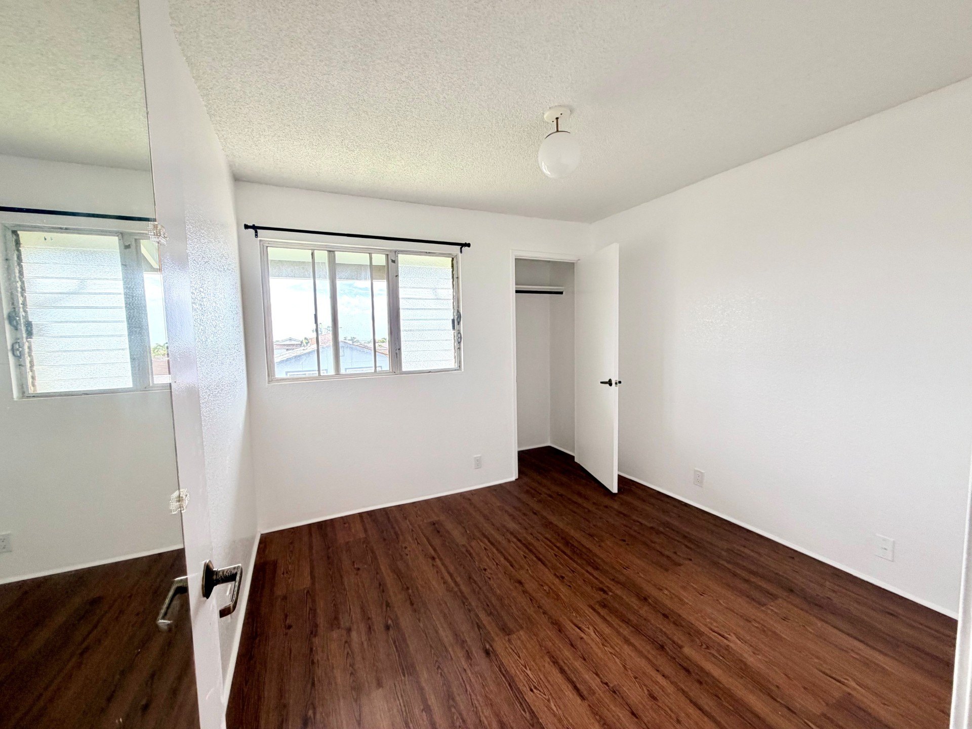A room with wooden floors and white walls.