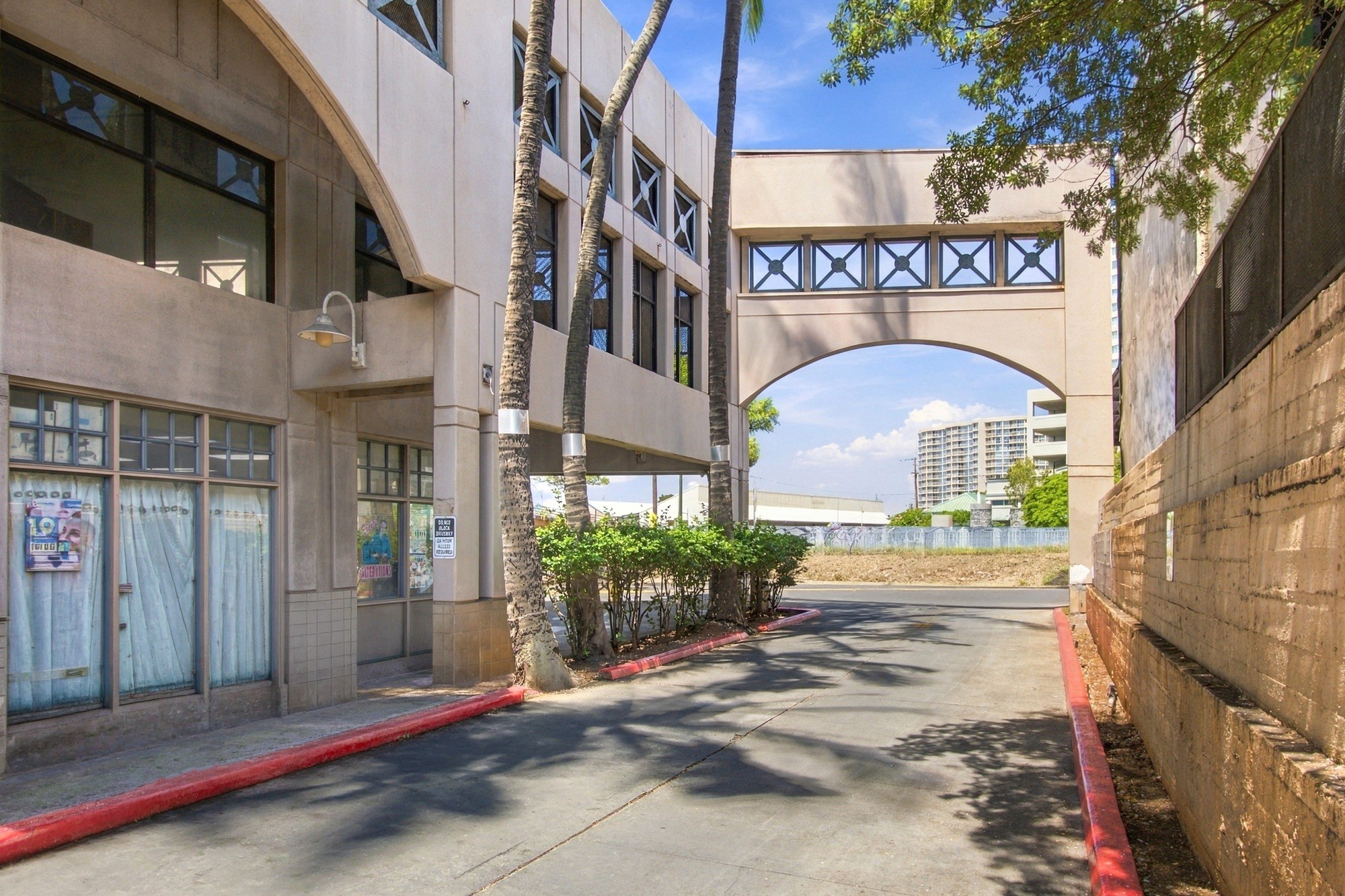 A building with a red curb and a white sign on the window.