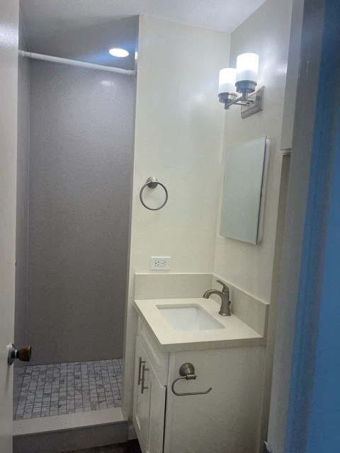 a small bathroom with a sink and a shower