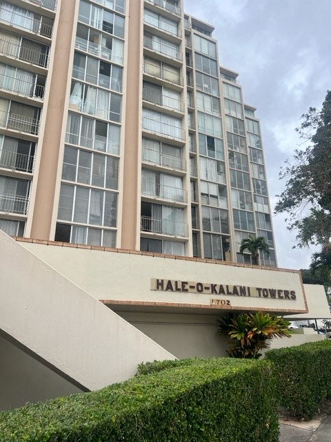 an apartment building with a hale o kalam towers sign