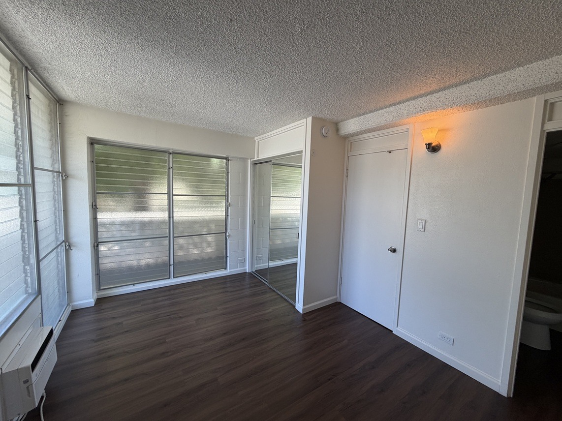 A room with a sliding glass door and a white door.