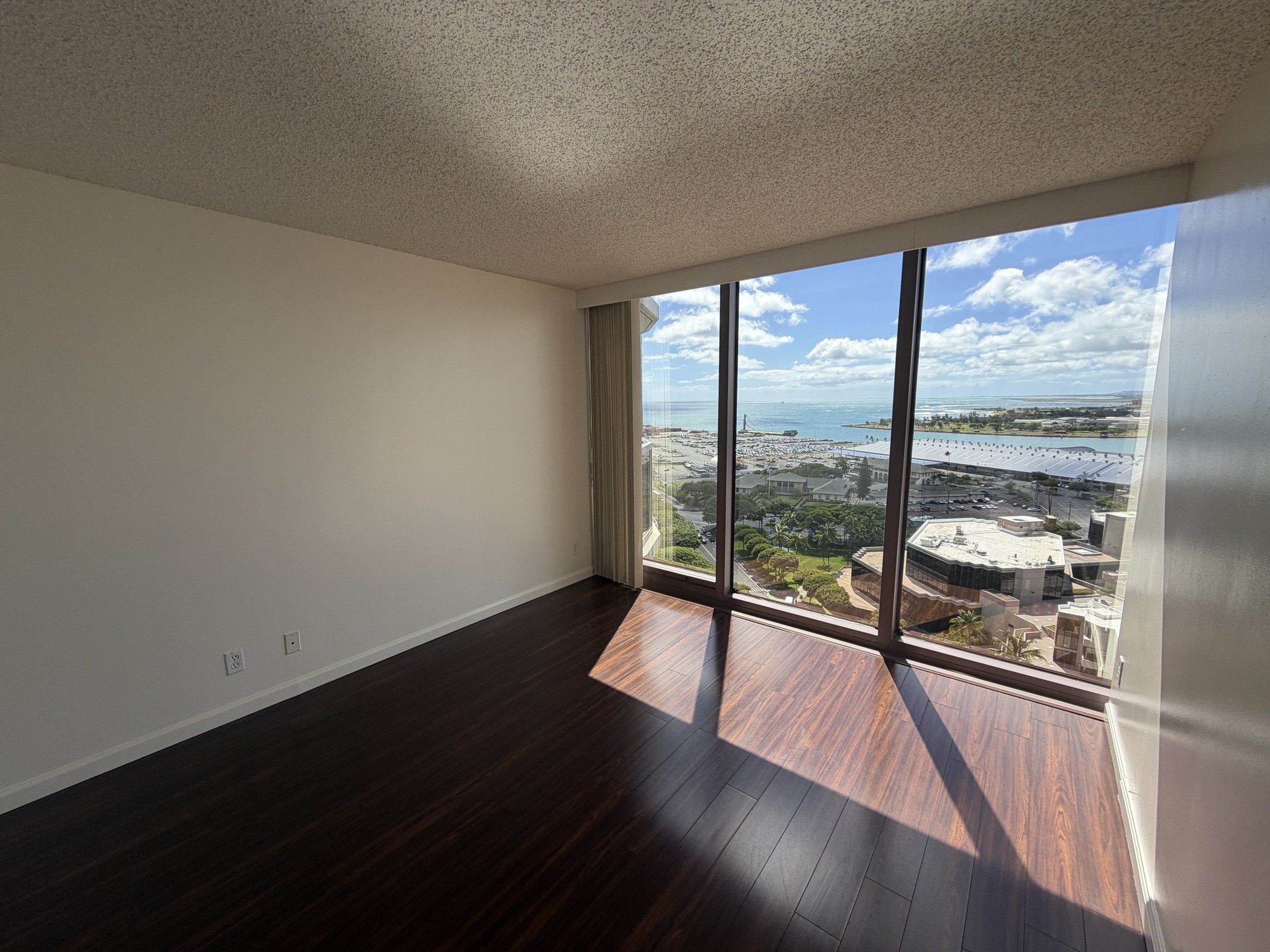 A room with a view of the city and water.