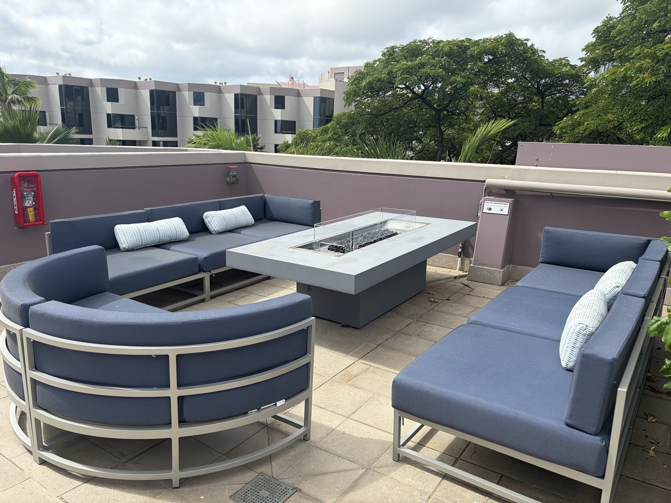 A blue couch and a table are on a patio.