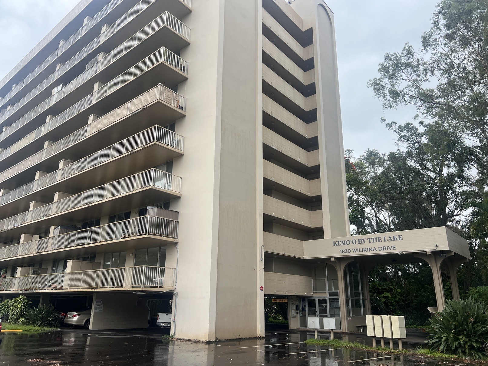 A tall building with a balcony on the second floor from the ground.