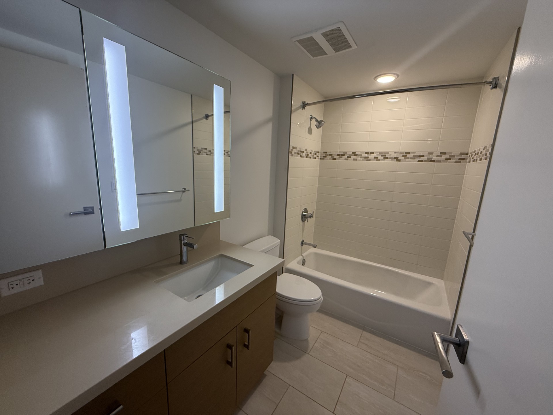 A white bathroom with a sink, toilet, and bathtub.