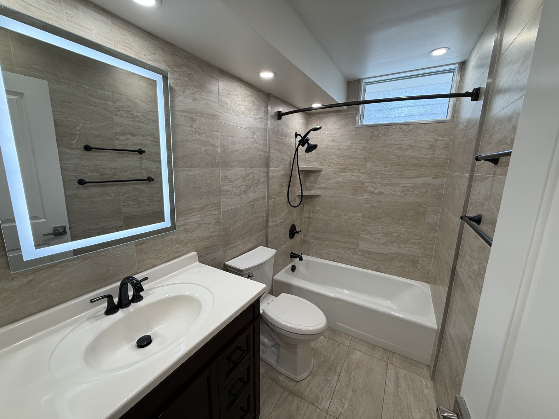A bathroom with a white sink, a white toilet, and a white bathtub.