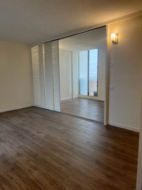 an empty living room with a hard wood floor