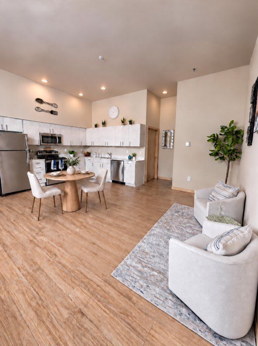 A modern kitchen with a dining table and chairs.