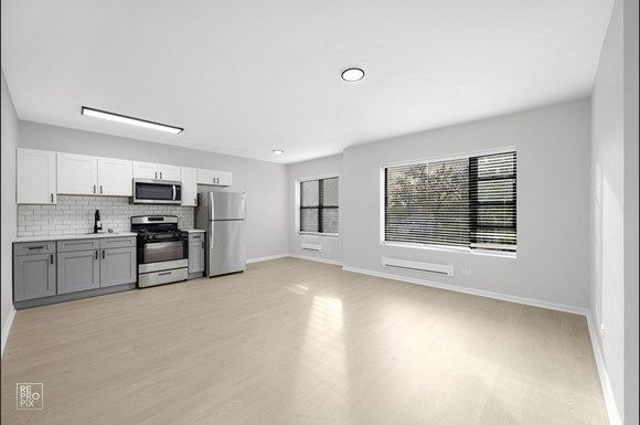 a spacious kitchen with stainless steel appliances and a large window