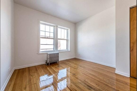 an empty room with a radiator and a window