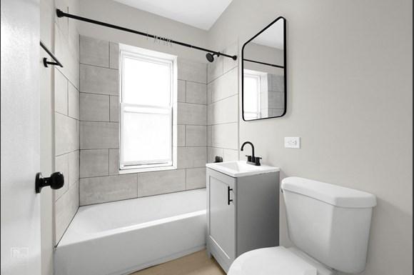 a bathroom with grey walls and a white bathtub with a shower curtain
