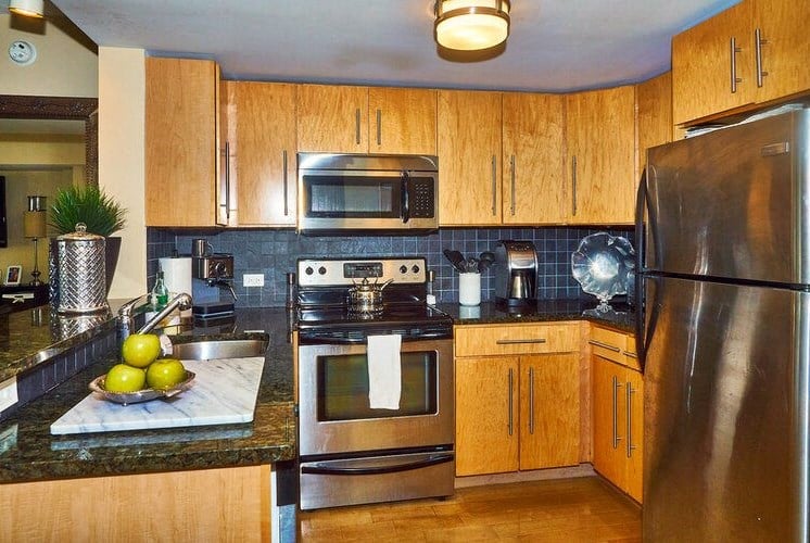 66 Main - Kitchen w/ Granite Counter and Backsplash