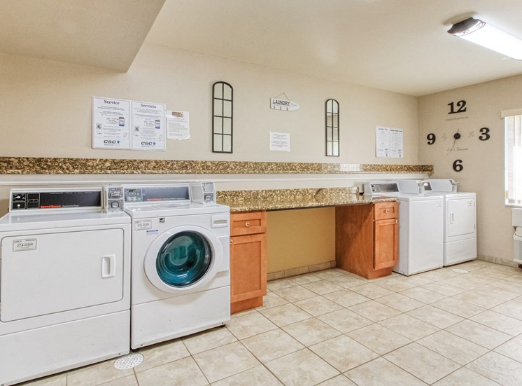 laundry center with washers and dryers and folding area