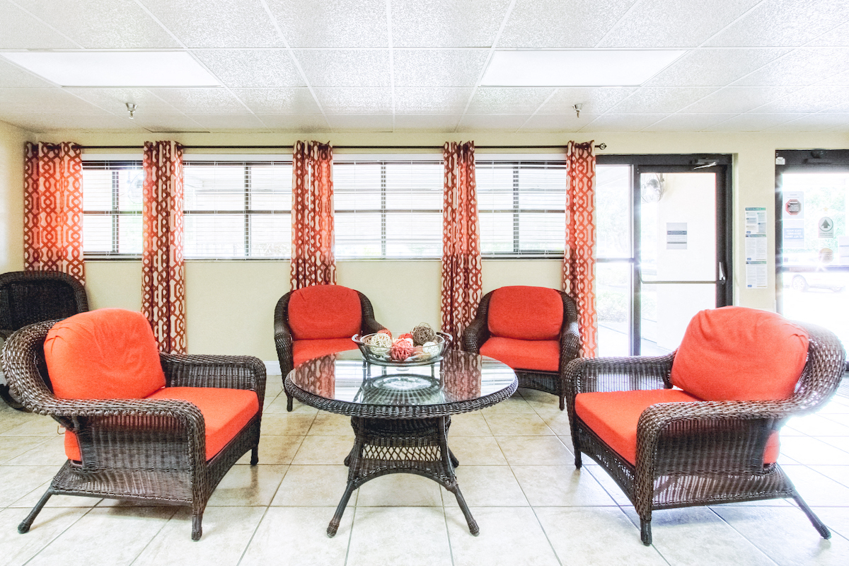 lobby with chairs, table, and sofa by bank of windows