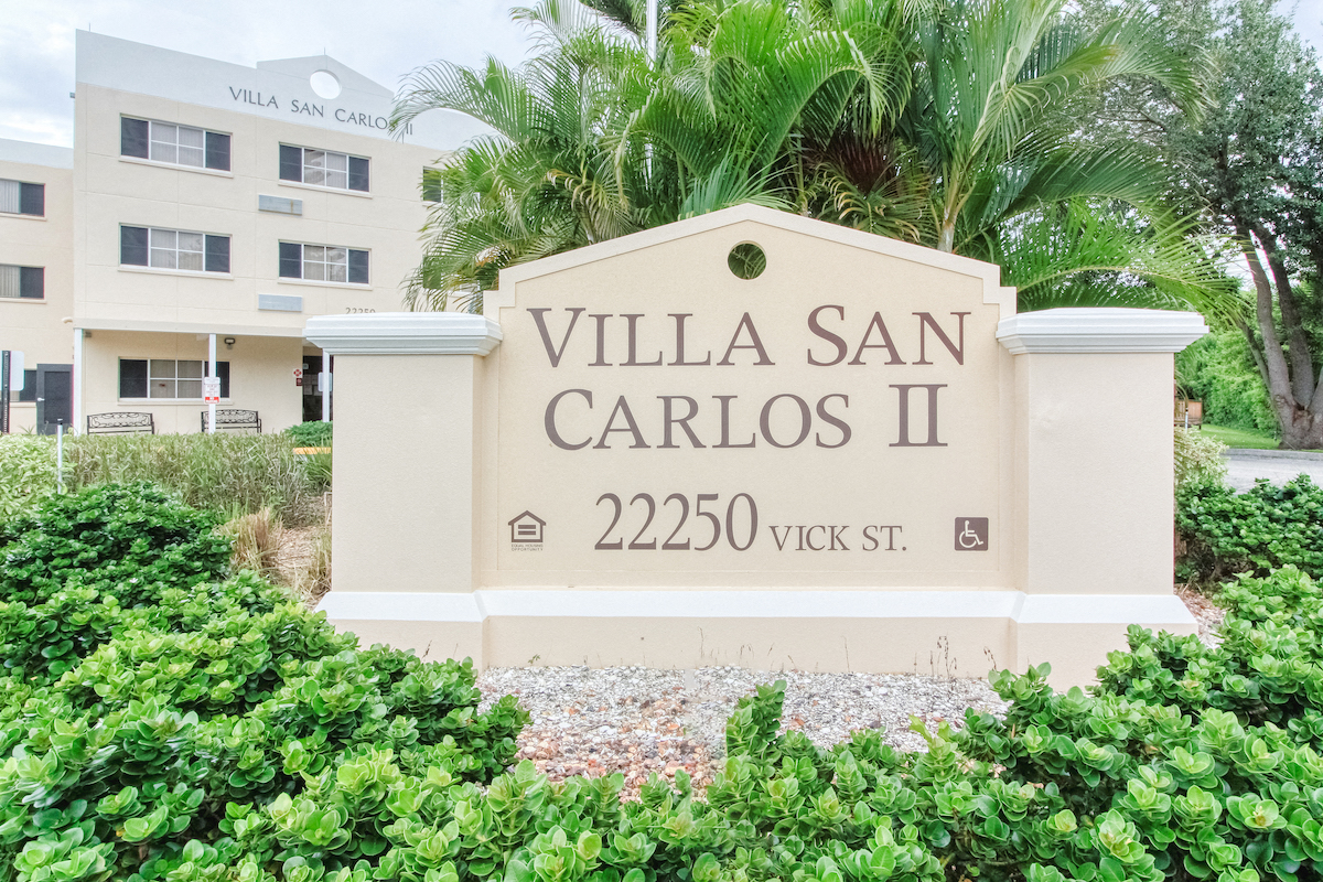 Signage in front of Villa San Carlos Senior Apartments in Port Charolette
