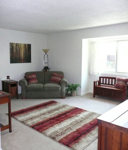 Living Room With Expansive Window at Emerald Court, Iowa