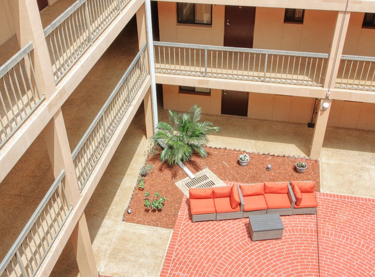 balconies looking into courtyard patio with swings and plants