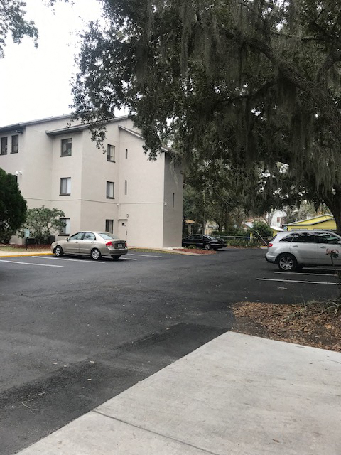 Cars parked at The Oaks Senior Apartments in St. Augustine, FL