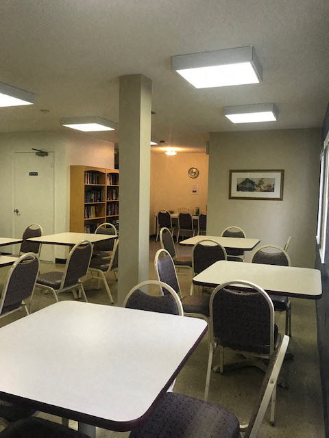 Community room with tables and chairs for residents