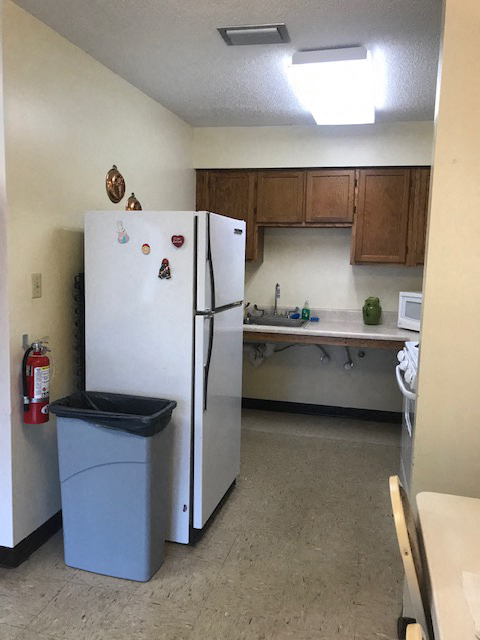 community kitchen area with fridge
