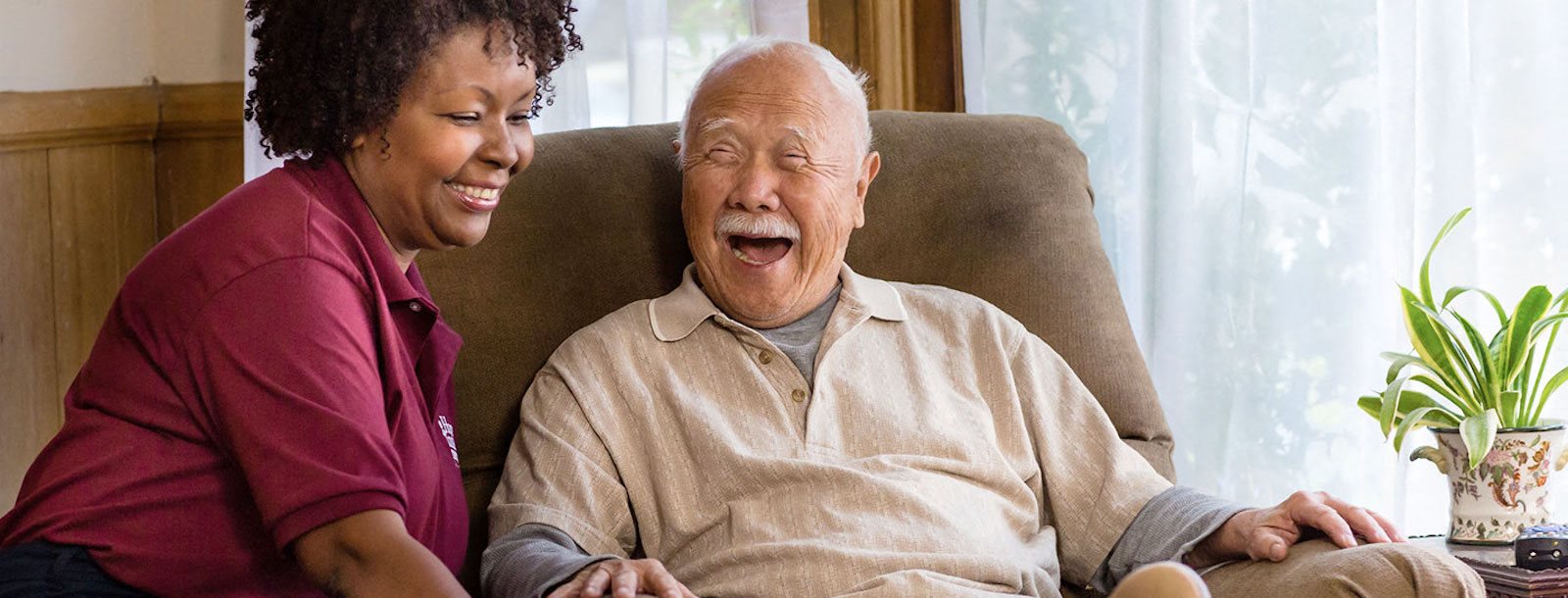 resident and staff member sharing a laugh together
