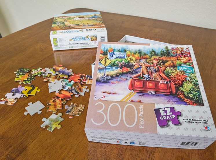 puzzles sitting on a table for residents to enjoy at Sundale Manor Senior Apartments