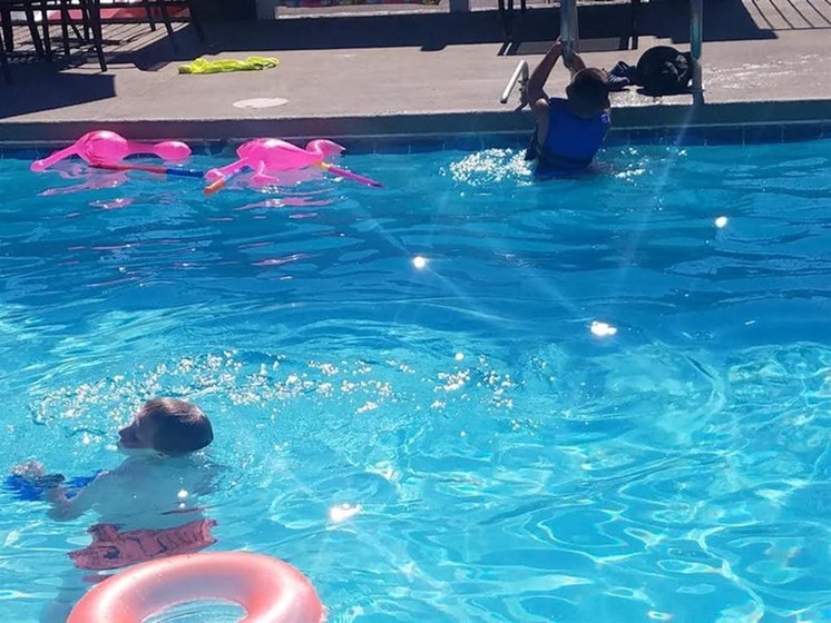 Family swimming in Pool Apartments for rent in Albuquerque NM l Villa La Charles