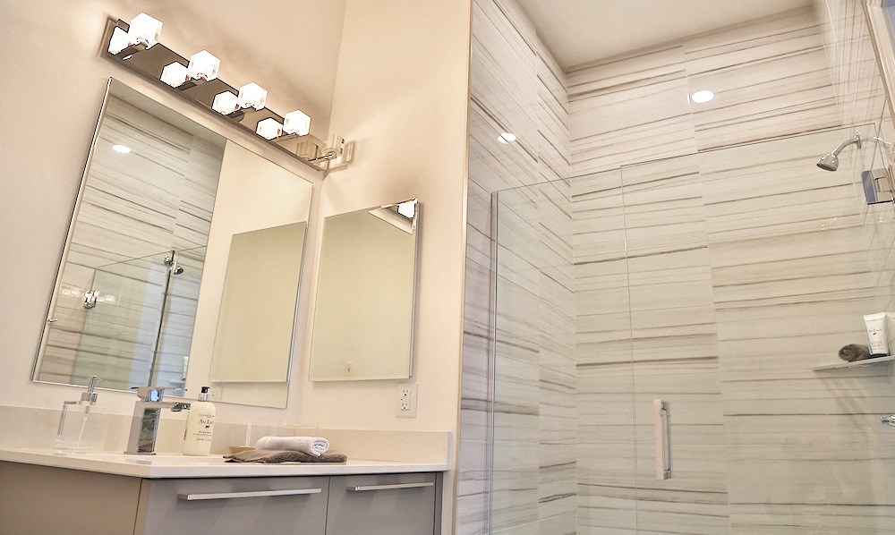 A bathroom with a shower in one of The James Ferndale senior apartments