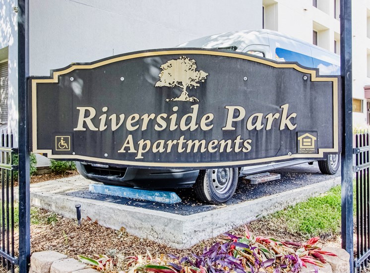 Monument sign outside of Riverside Park Apartments with name of community on sign