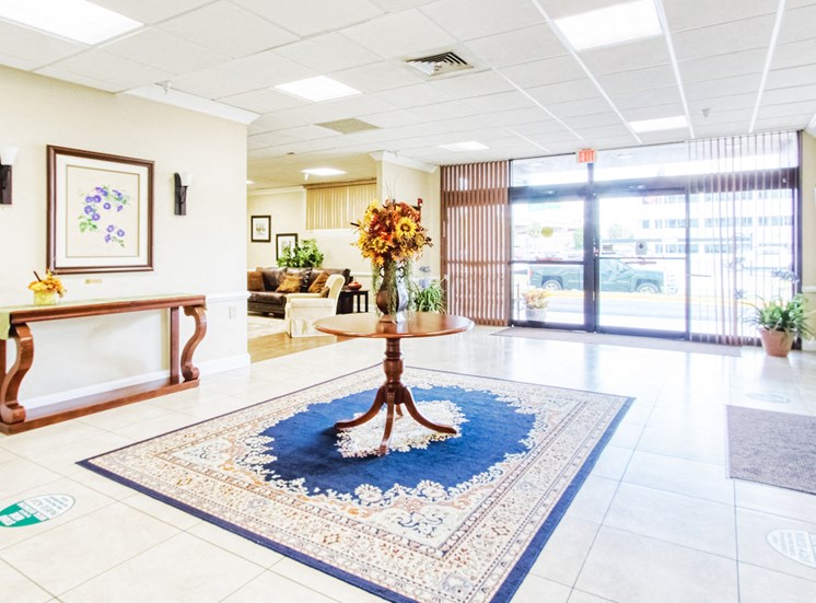 lobby with beautiful flower arrangement on table in entranceway