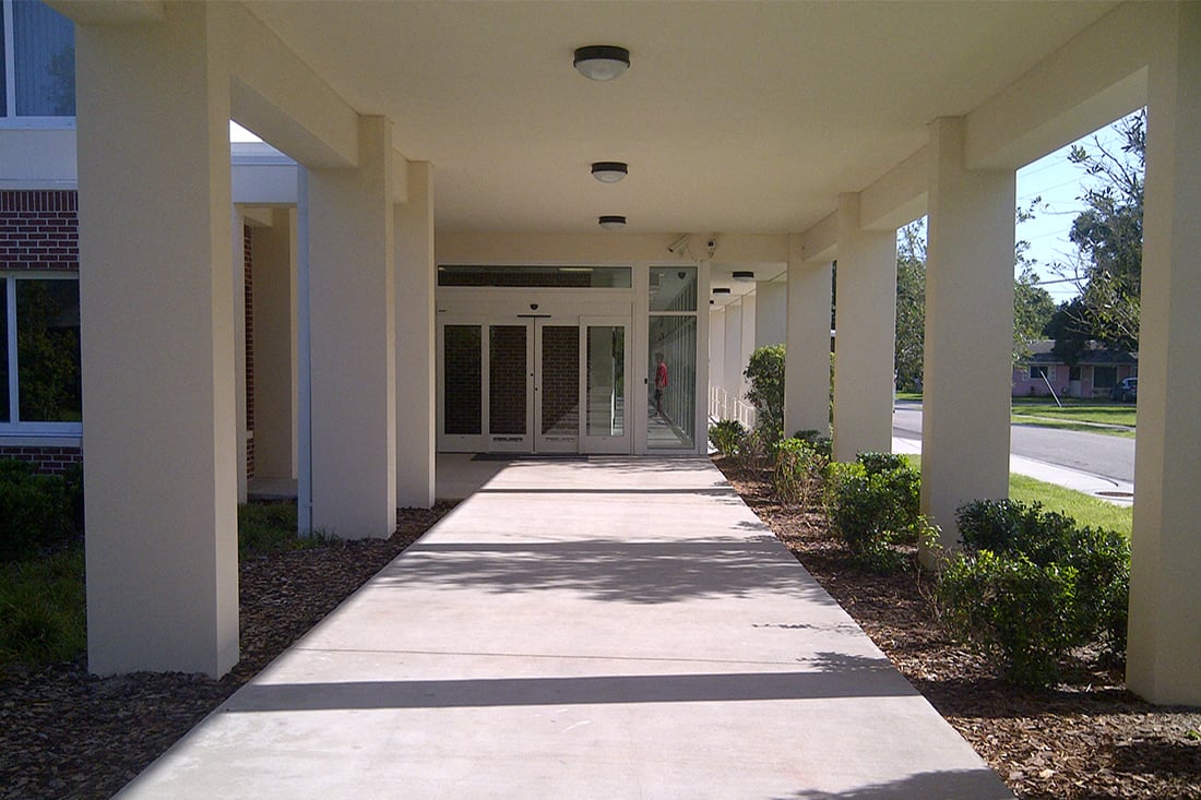 covered walkway with neat landscaping at St. Giles Manor II