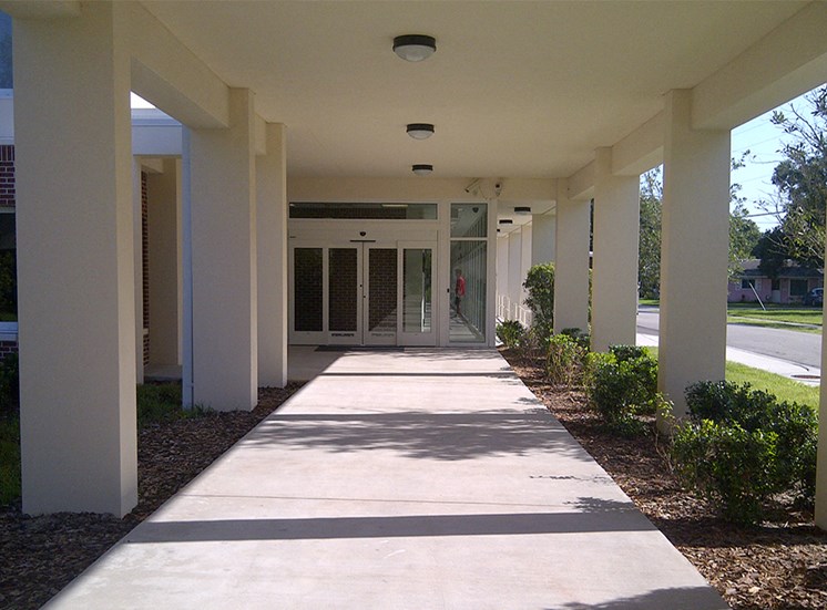 covered walkway with neat landscaping at St. Giles Manor II