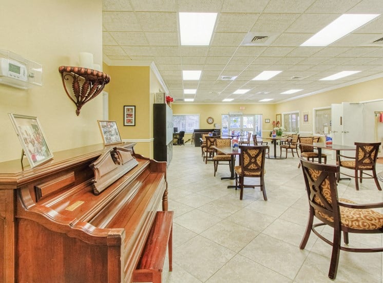 Piano in community room with ample seating