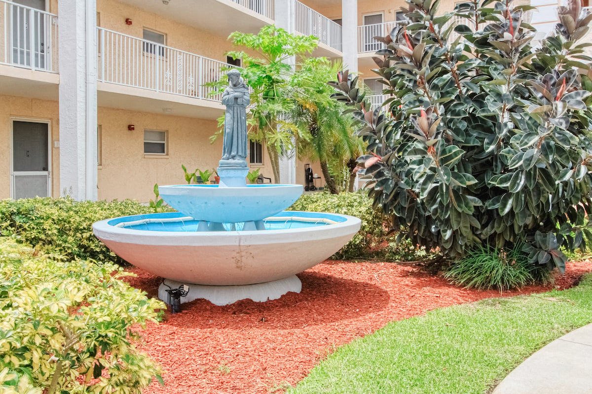 Beautiful sparkling fountain in lushly landscaped courtyard