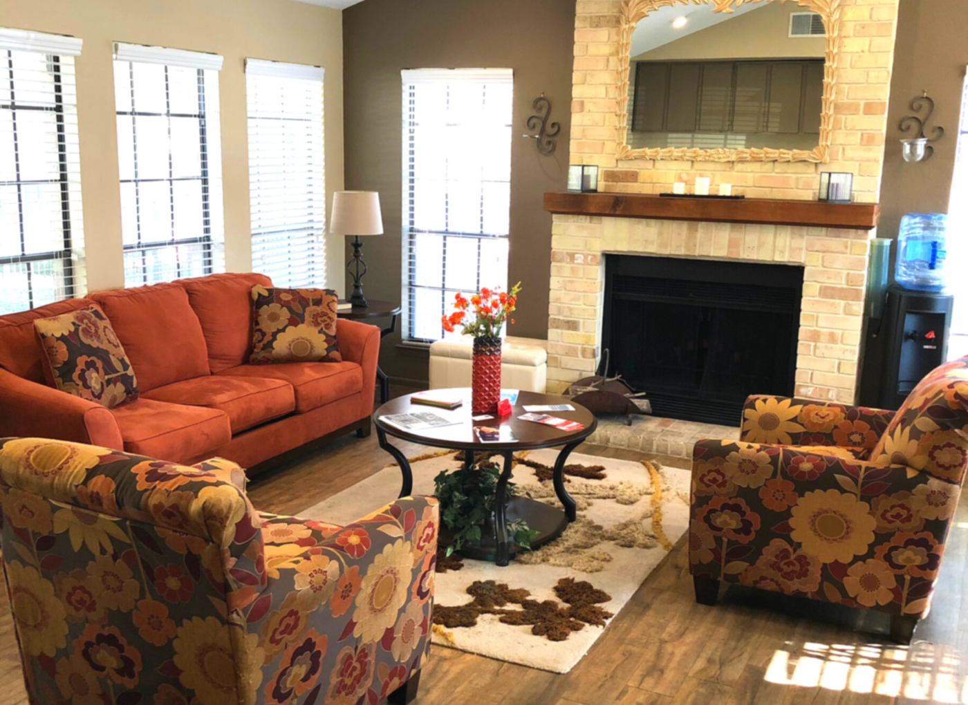 Clubhouse furniture with warm colors and a fireplace