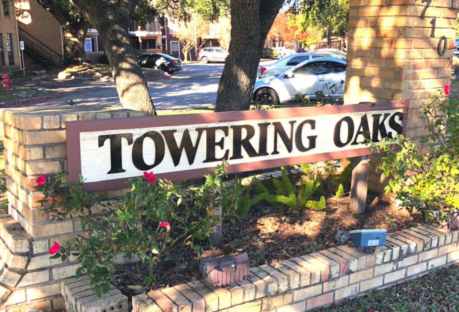 Community sign surrounded by flowers