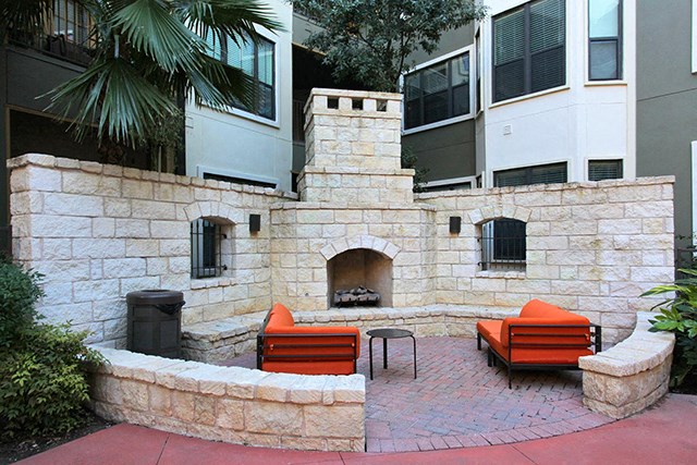 Outdoor Fireplace & Courtyard with couch seating
