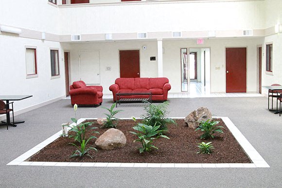 The Atriums study lounge with natural lighting, seating, and tables