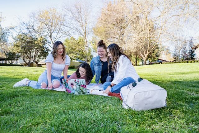 Residents sit on the grass area at Chautauqua