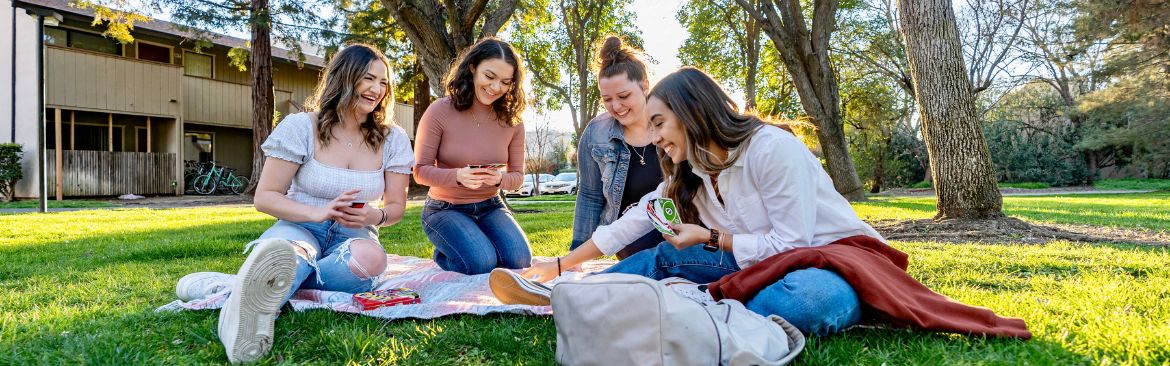 Residents sit on the grass area at Chautauqua